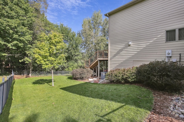 view of yard featuring fence, central AC unit, a wooden deck, and stairs