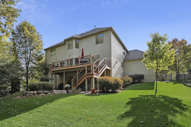 back of property with stairs, a yard, a deck, and fence