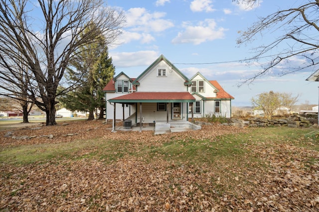 rear view of house with cooling unit and a porch