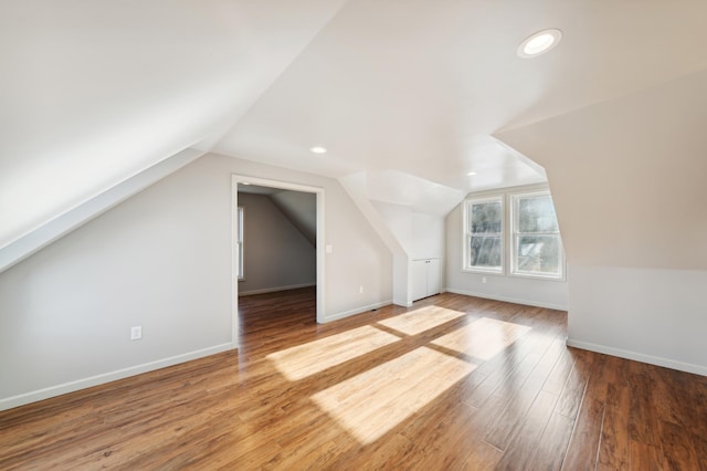 bonus room featuring lofted ceiling and wood-type flooring