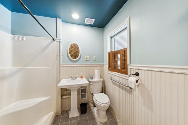 bathroom with tile patterned flooring and toilet