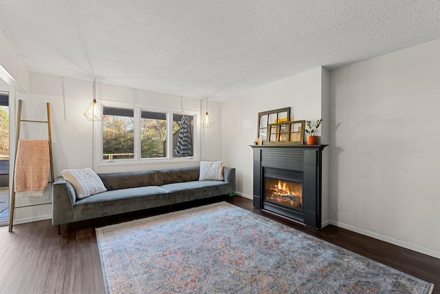 living room featuring a textured ceiling and dark hardwood / wood-style flooring