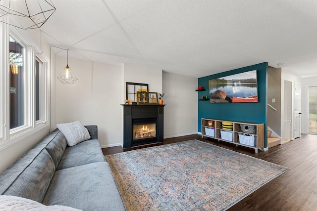 living room featuring dark hardwood / wood-style flooring and a textured ceiling