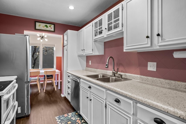 kitchen featuring sink, dishwasher, double oven range, dark hardwood / wood-style floors, and white cabinets