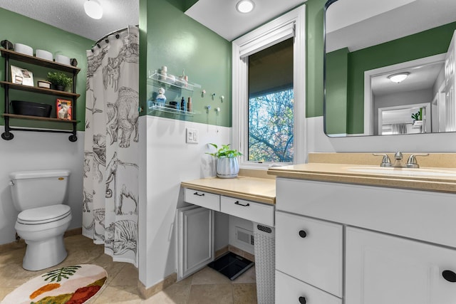 bathroom with vanity, tile patterned floors, and toilet