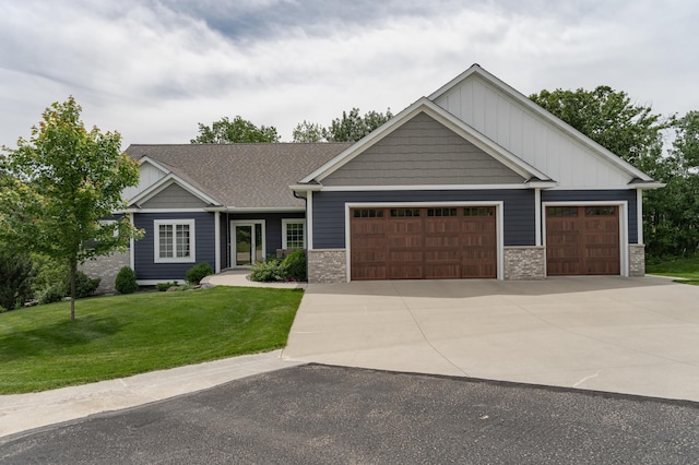 craftsman-style house featuring a garage and a front yard