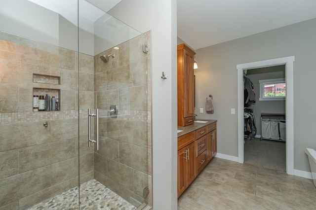 bathroom with tile patterned flooring, vanity, and an enclosed shower