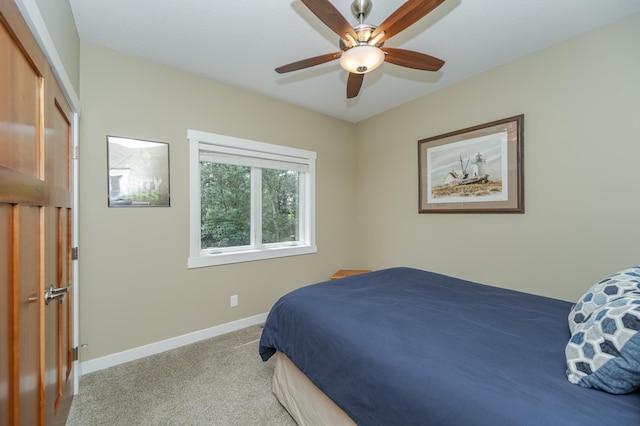 bedroom featuring ceiling fan, light carpet, and a closet