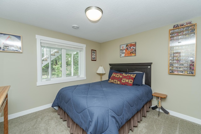 carpeted bedroom with a textured ceiling