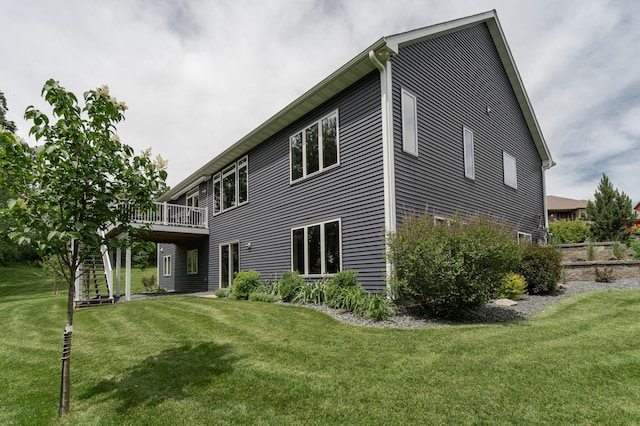 rear view of house with a deck and a yard