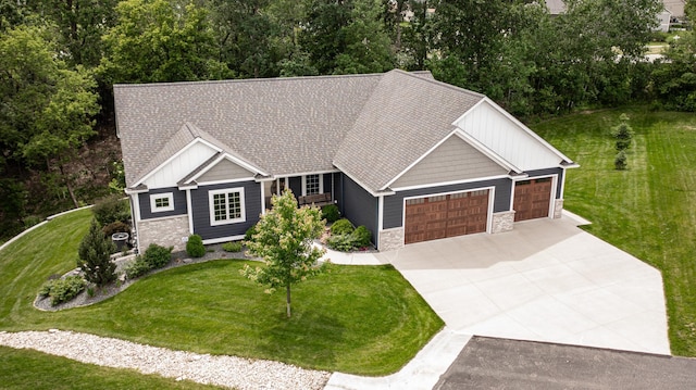 craftsman inspired home featuring a garage and a front yard