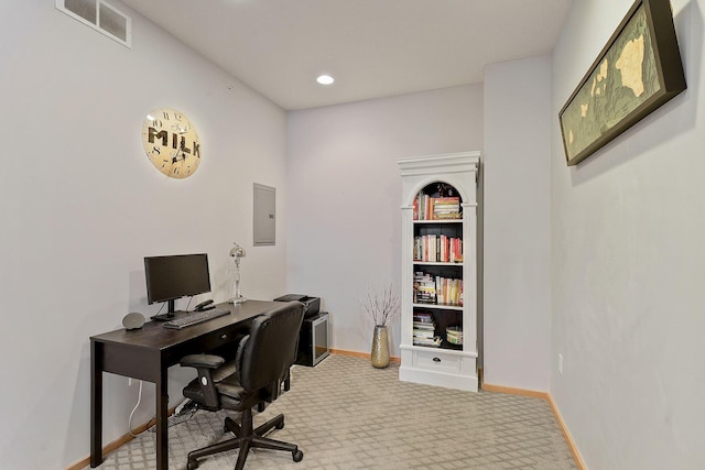 carpeted office featuring electric panel