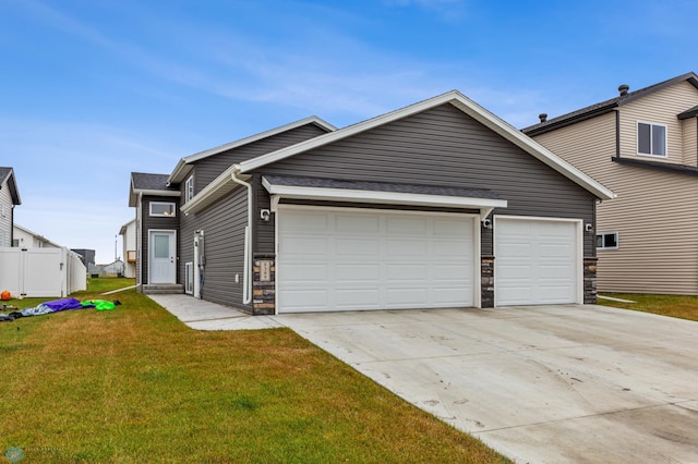 view of front of property with a garage and a front yard