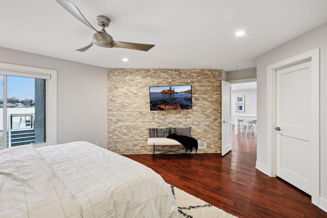 bedroom featuring dark hardwood / wood-style floors, access to outside, and ceiling fan