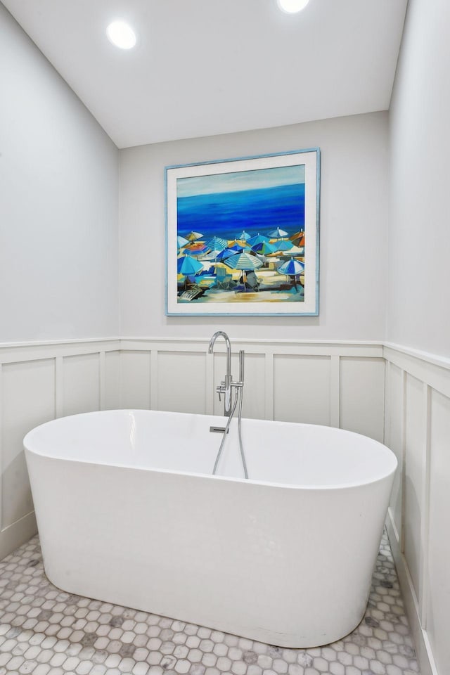 bathroom with tile patterned floors and a tub