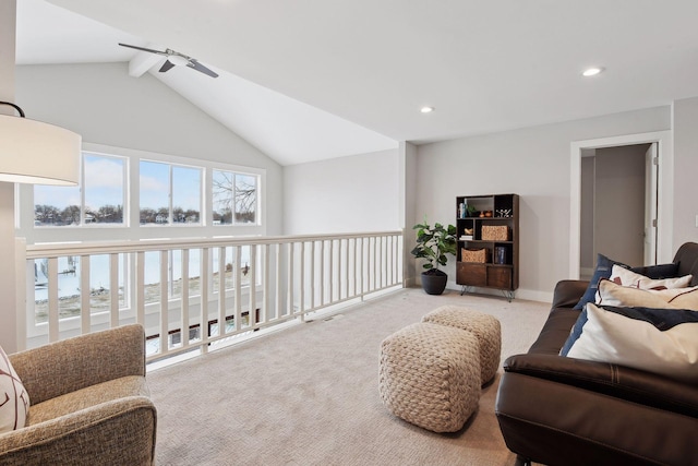 sitting room featuring light carpet, plenty of natural light, and lofted ceiling with beams