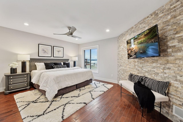 bedroom with dark hardwood / wood-style floors and ceiling fan