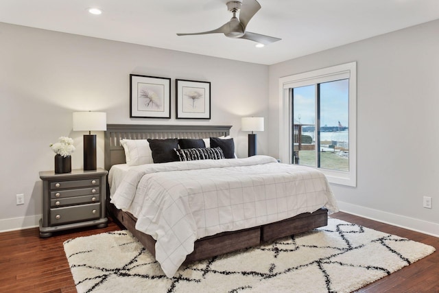 bedroom with dark hardwood / wood-style floors and ceiling fan