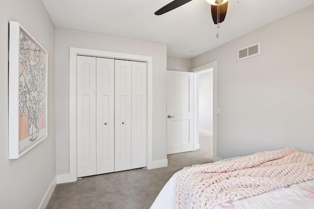 carpeted bedroom featuring ceiling fan and a closet