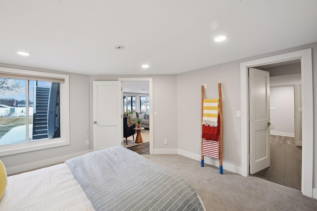 carpeted bedroom with multiple windows