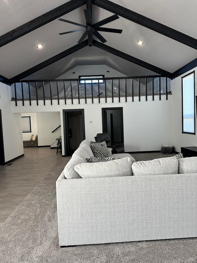 living room with hardwood / wood-style floors, lofted ceiling with beams, and ceiling fan