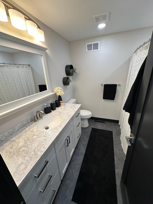 bathroom with toilet and vanity