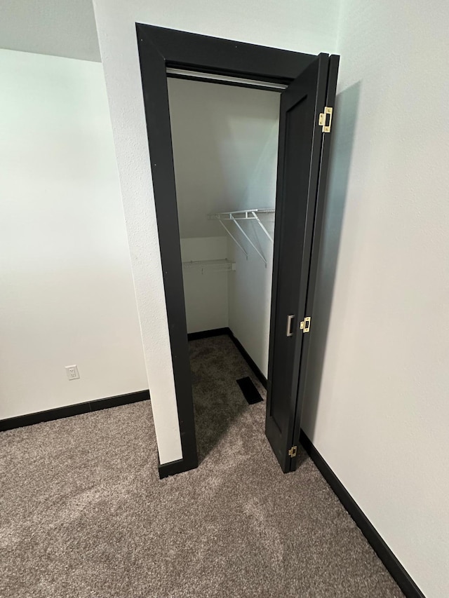 laundry room featuring dark carpet