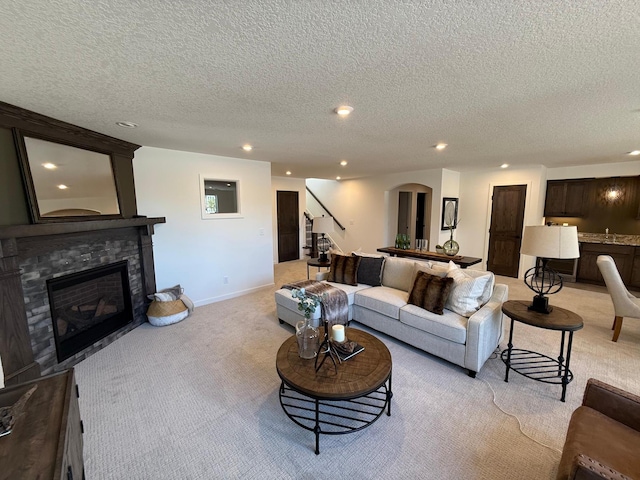 carpeted living room with a textured ceiling