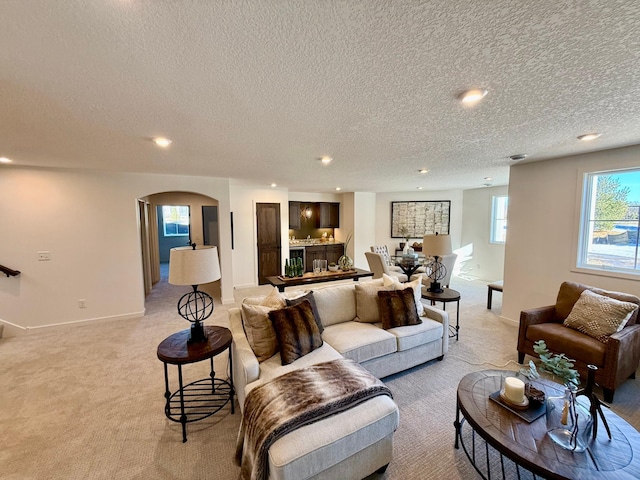 living room with light carpet and a textured ceiling