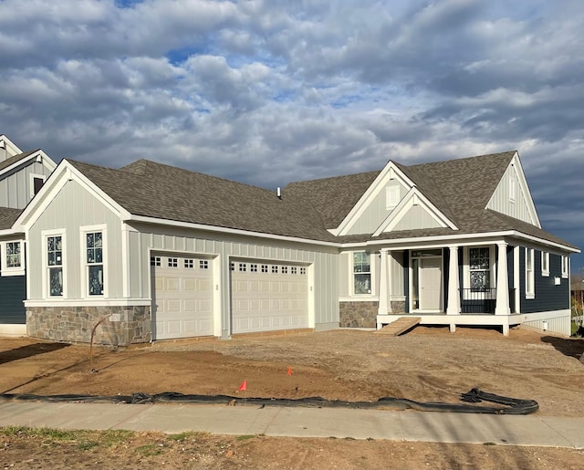 view of front facade with a porch and a garage