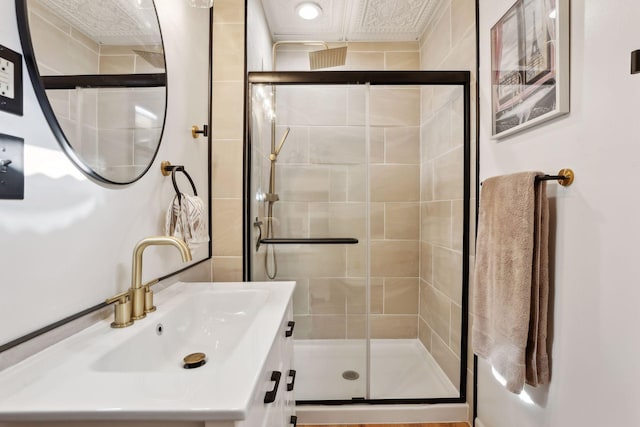 bathroom featuring an enclosed shower and vanity