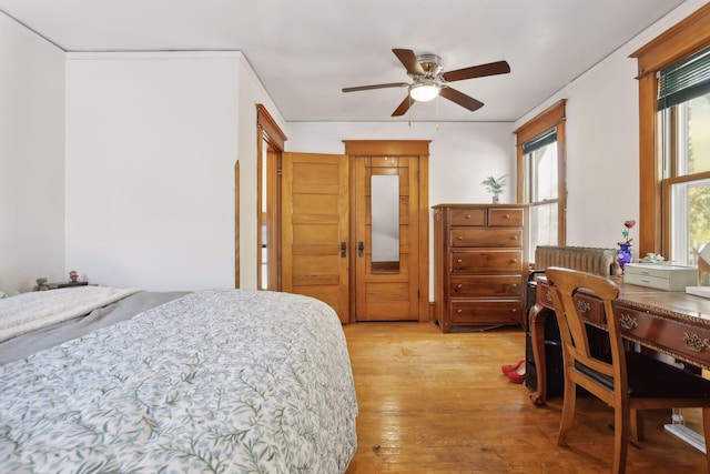 bedroom with light hardwood / wood-style flooring and ceiling fan