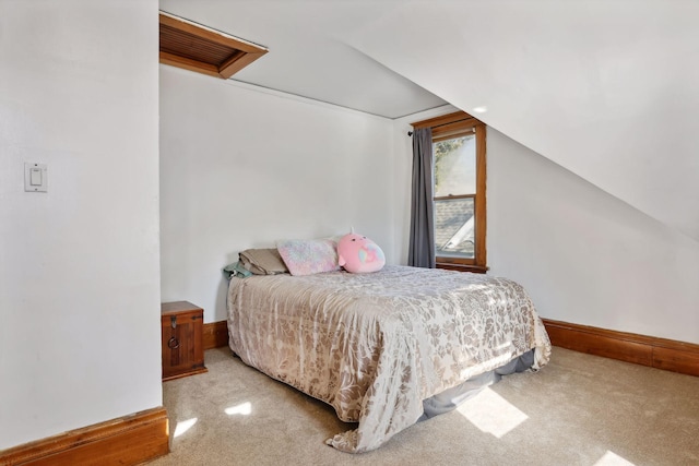 carpeted bedroom featuring lofted ceiling