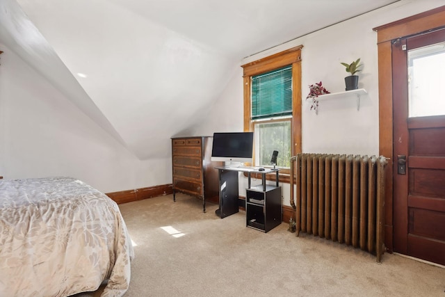 carpeted bedroom featuring vaulted ceiling and radiator