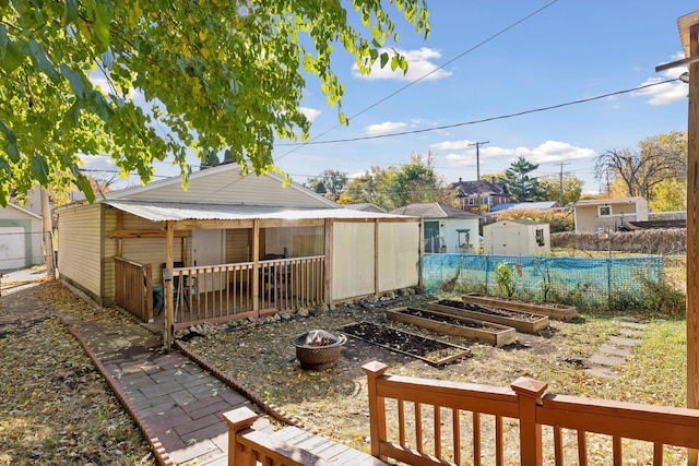 view of yard featuring a shed and a fire pit