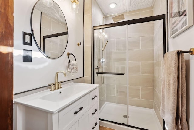 bathroom featuring vanity and a shower with door