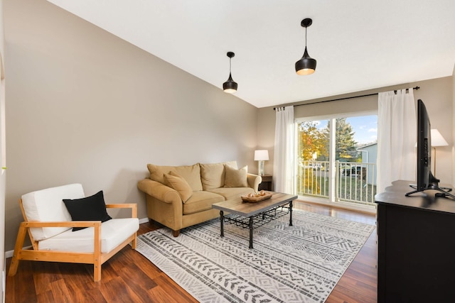 living room featuring hardwood / wood-style flooring and vaulted ceiling