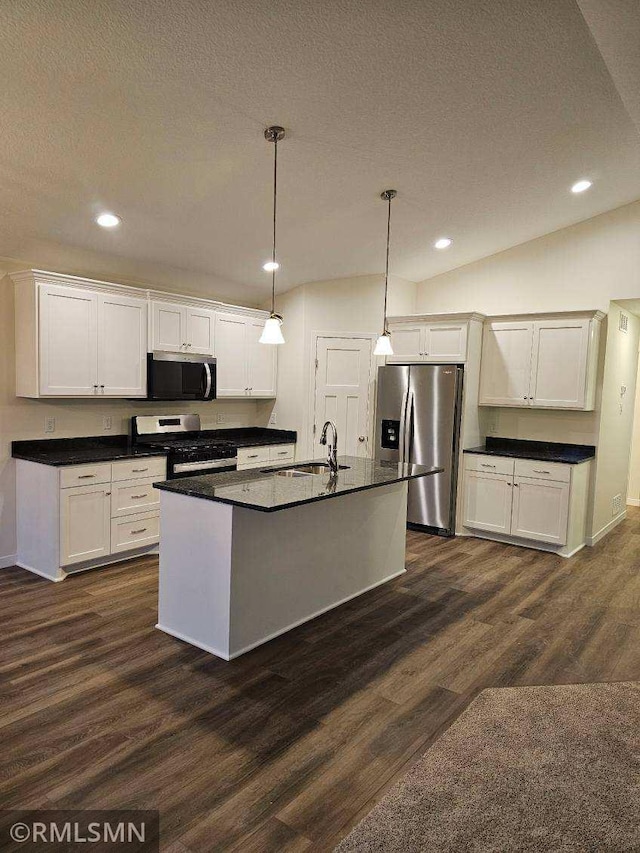 kitchen featuring white cabinetry, dark hardwood / wood-style flooring, an island with sink, decorative light fixtures, and appliances with stainless steel finishes