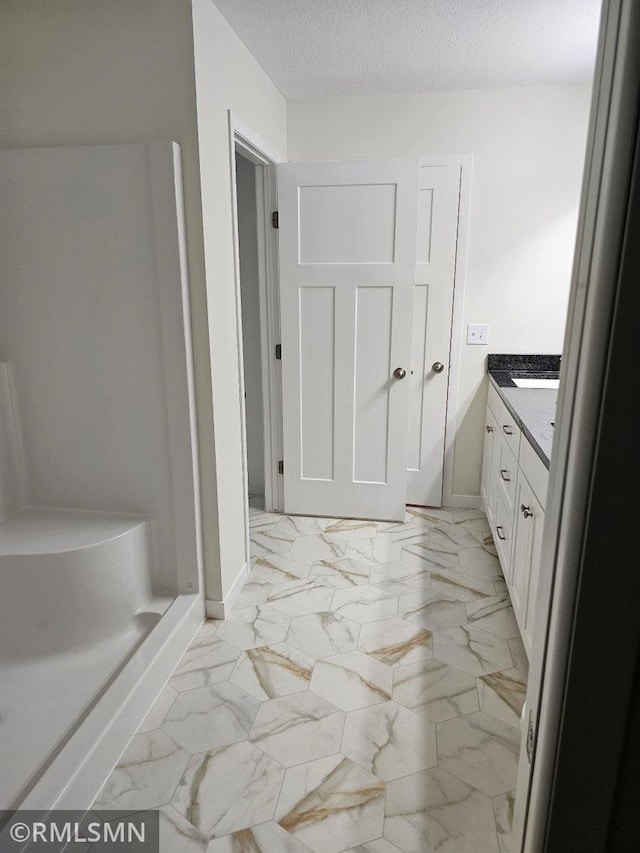 bathroom with vanity and a textured ceiling