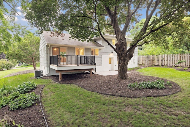 back of house featuring a yard and central AC unit