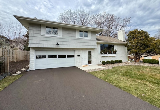 view of front facade featuring a garage and a front lawn