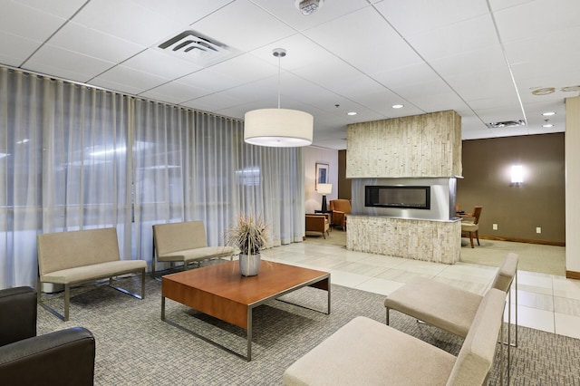 living room with tile patterned floors and a large fireplace