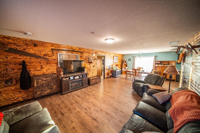 living room with hardwood / wood-style floors and a textured ceiling