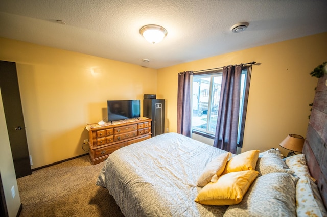 carpeted bedroom featuring a textured ceiling