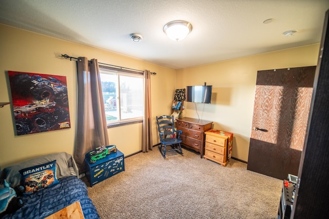 bedroom with light carpet and a textured ceiling