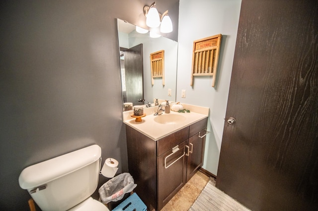 bathroom featuring tile patterned flooring, vanity, and toilet