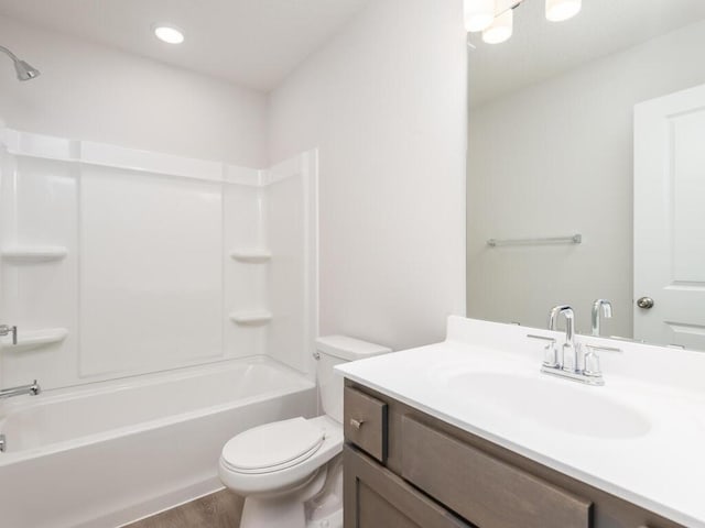 full bathroom featuring shower / tub combination, vanity, hardwood / wood-style flooring, and toilet