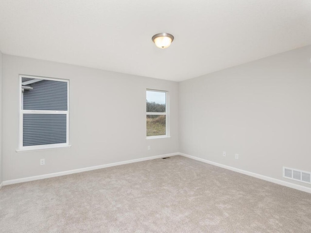 unfurnished room with light colored carpet