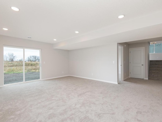 unfurnished room featuring light colored carpet