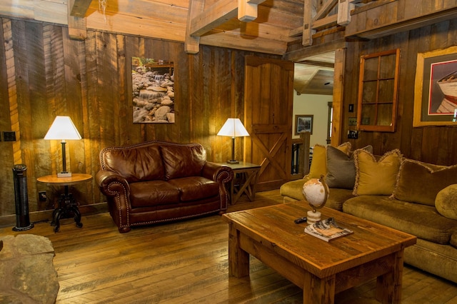 living room with hardwood / wood-style floors, wood walls, beamed ceiling, and wood ceiling